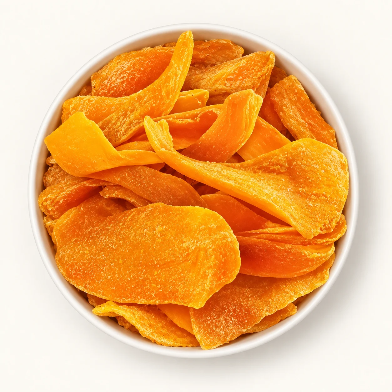 Golden dried mango in an ivory bowl